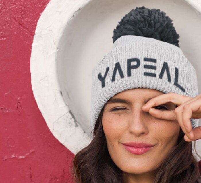 Woman wearing a Yapeal-branded knitted hat